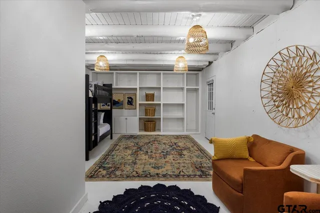 a spacious bedroom with a bed and a large window