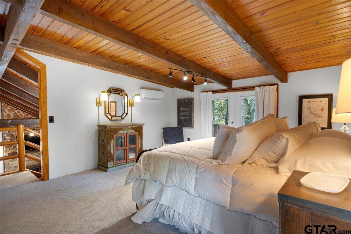 220 Dale Drive Avinger, TX 75630 - Photo 21 of 32 a bed sitting in a spacious bedroom next to a window