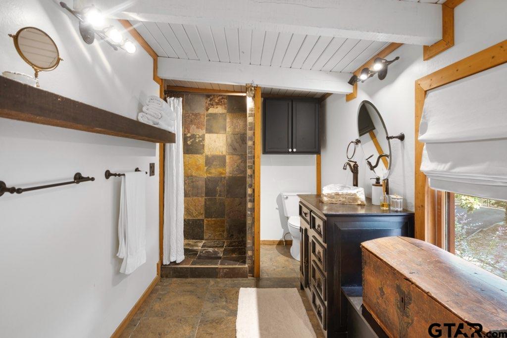 220 Dale Drive Avinger, TX 75630 - Photo 22 of 32 a bathroom with a double vanity sink toilet and shower