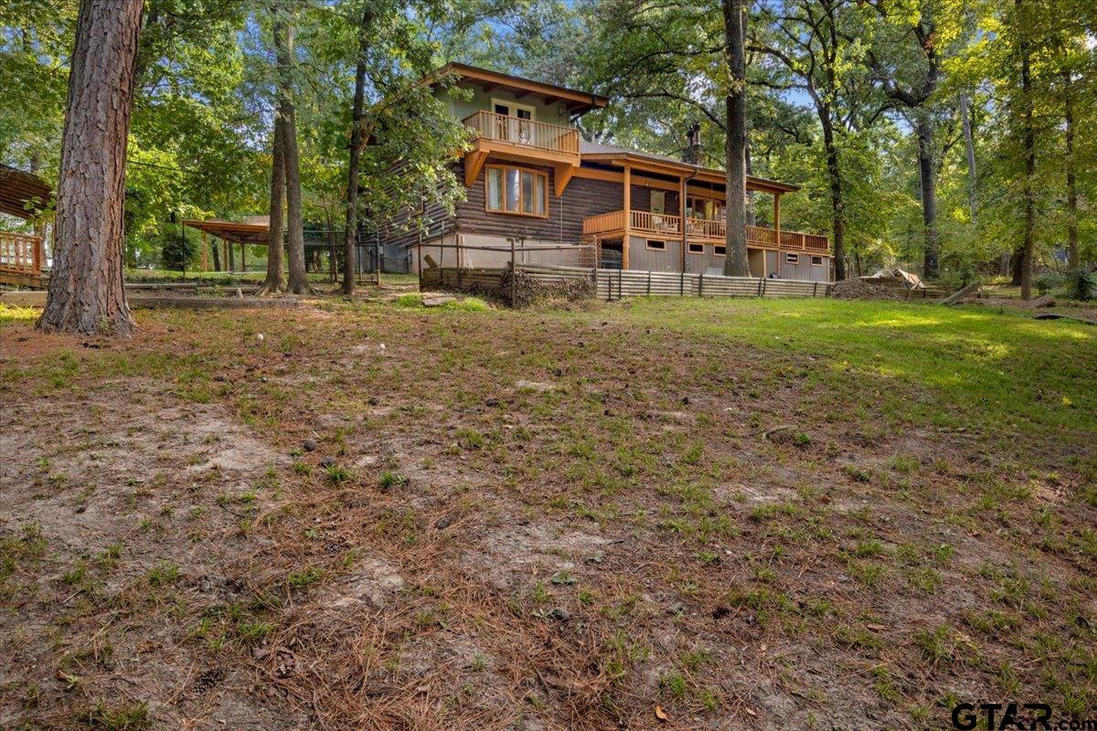 220 Dale Drive Avinger, TX 75630 - Photo 28 of 32 a view of a yard with large tree in front of a house
