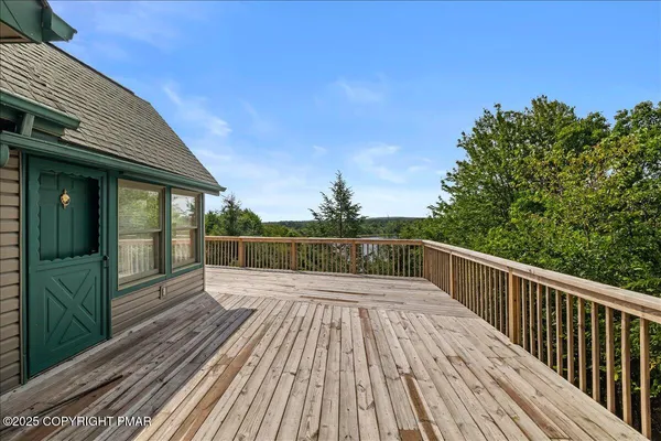 a view of balcony with wooden floor and fence