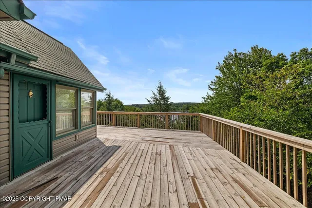 a view of balcony with wooden floor and fence