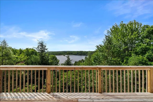 a balcony with wooden floor and fence