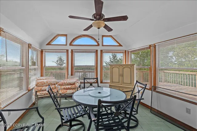 a view of a dining room with furniture large windows and wooden floor