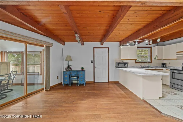 a kitchen with stainless steel appliances granite countertop a refrigerator and a table