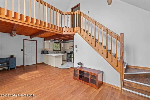 a view of entryway kitchen and hall with wooden floor