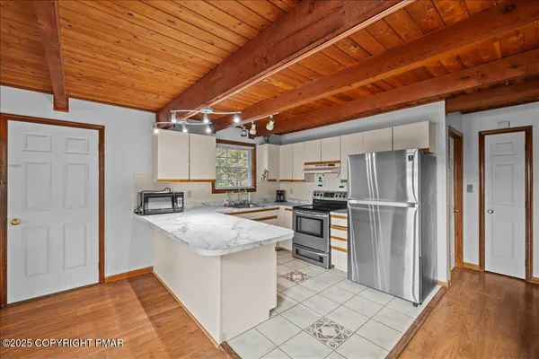 a kitchen with refrigerator and cabinets
