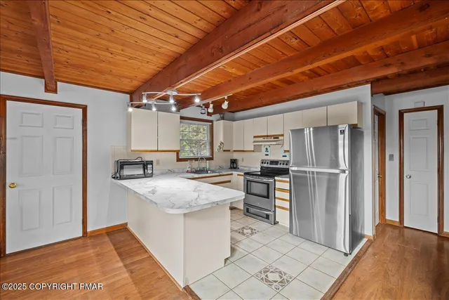 a kitchen with refrigerator and cabinets