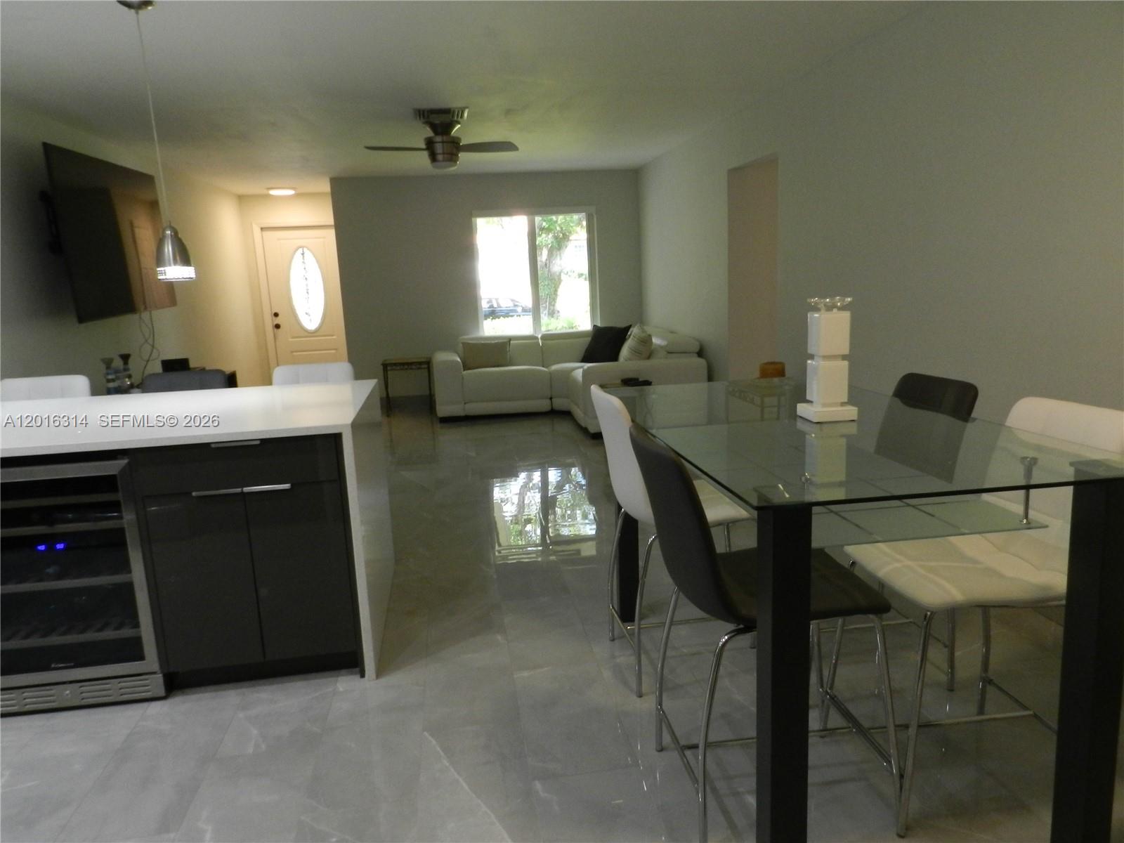 305 Northwest 42nd Street Boca Raton, FL 33431 - Photo 24 of 31 a view of a dining room with furniture and a flat screen tv