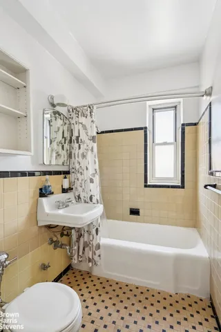 a bedroom with a bed next to a large window