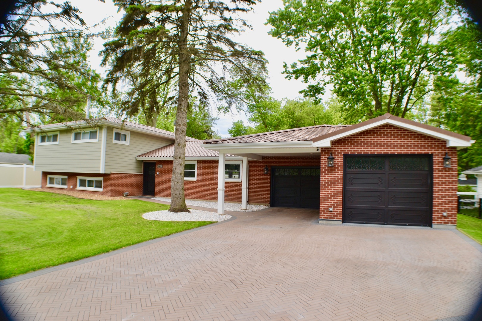 2014 Driving Park Road Wheaton, IL 60187 - Photo 1 of 32 a front view of a house with a yard and garage