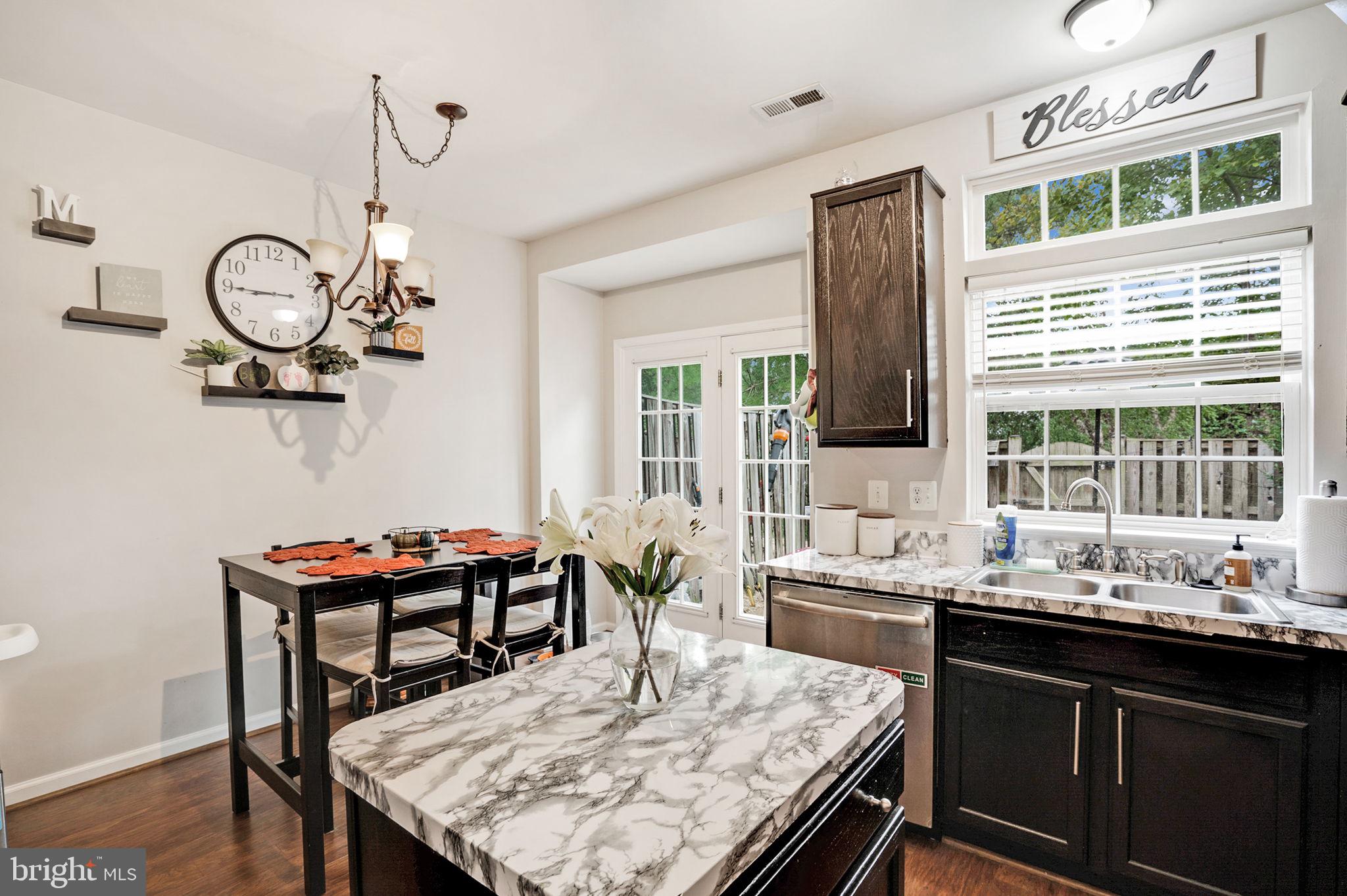9835 Maitland Loop Bristow, VA 20136 - Photo 13 of 41 a kitchen with a table chairs and a window