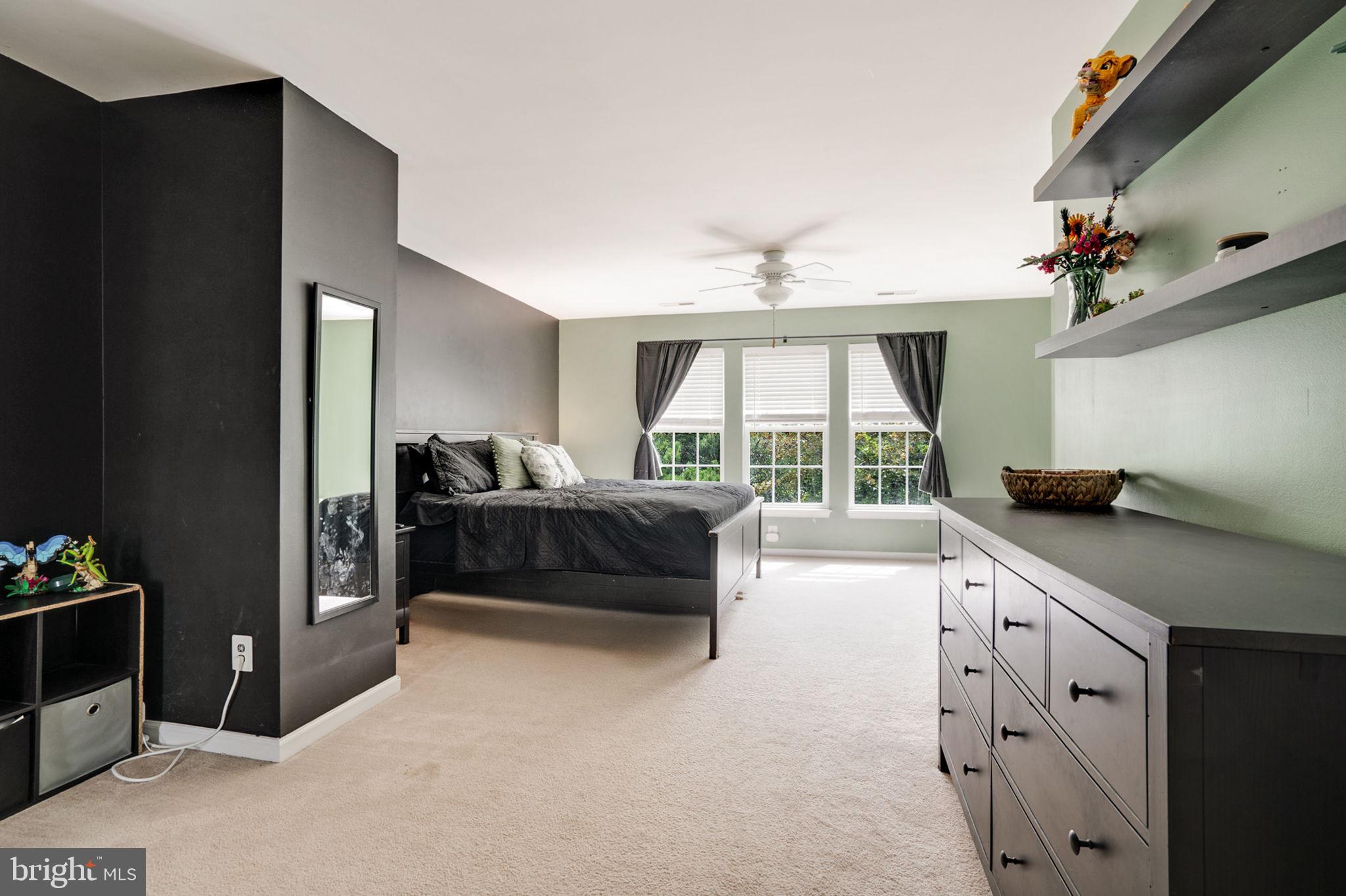 9835 Maitland Loop Bristow, VA 20136 - Photo 20 of 41 a spacious bedroom with a bed and a large window