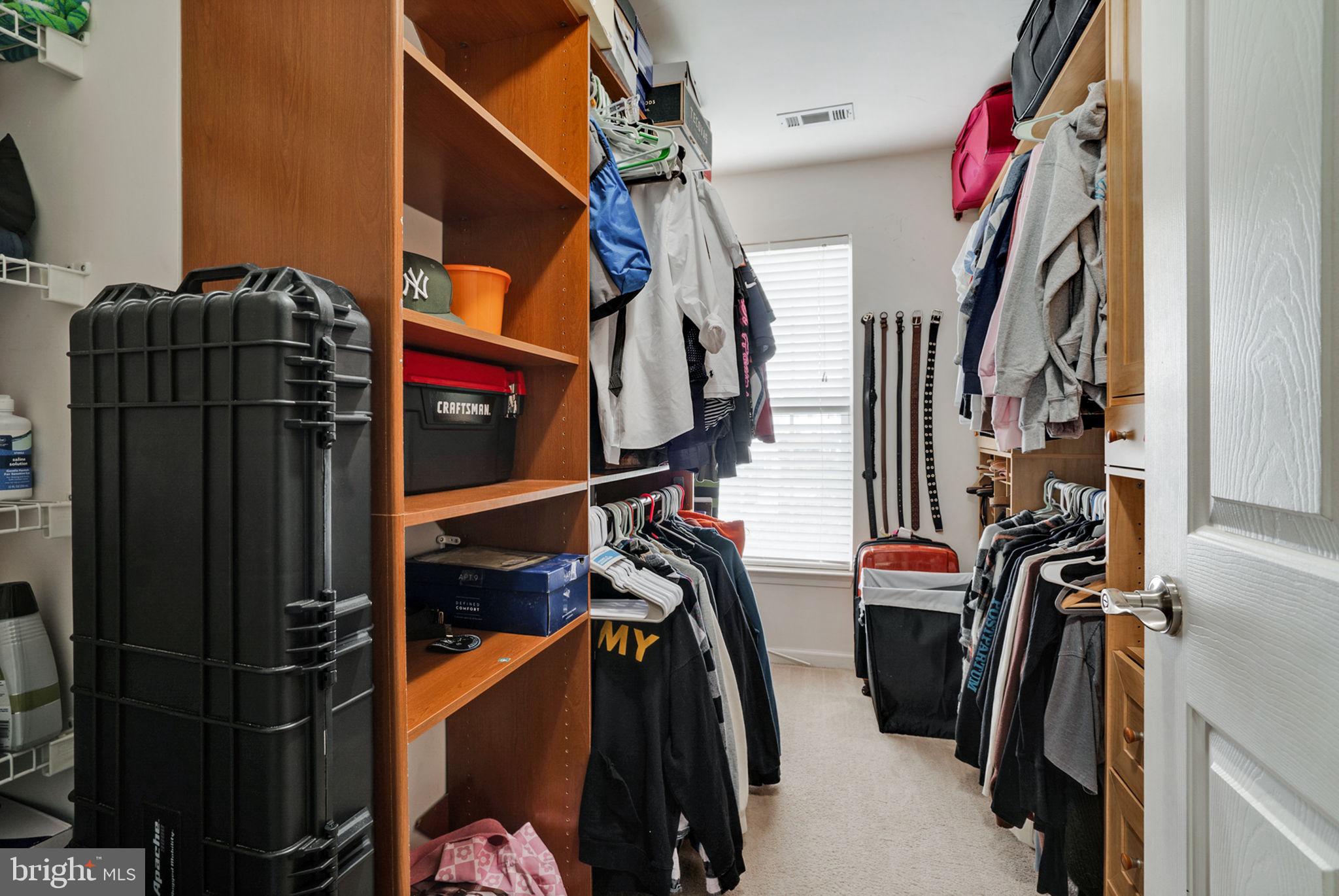 9835 Maitland Loop Bristow, VA 20136 - Photo 24 of 41 a view of walk in closet with clothes and shoes