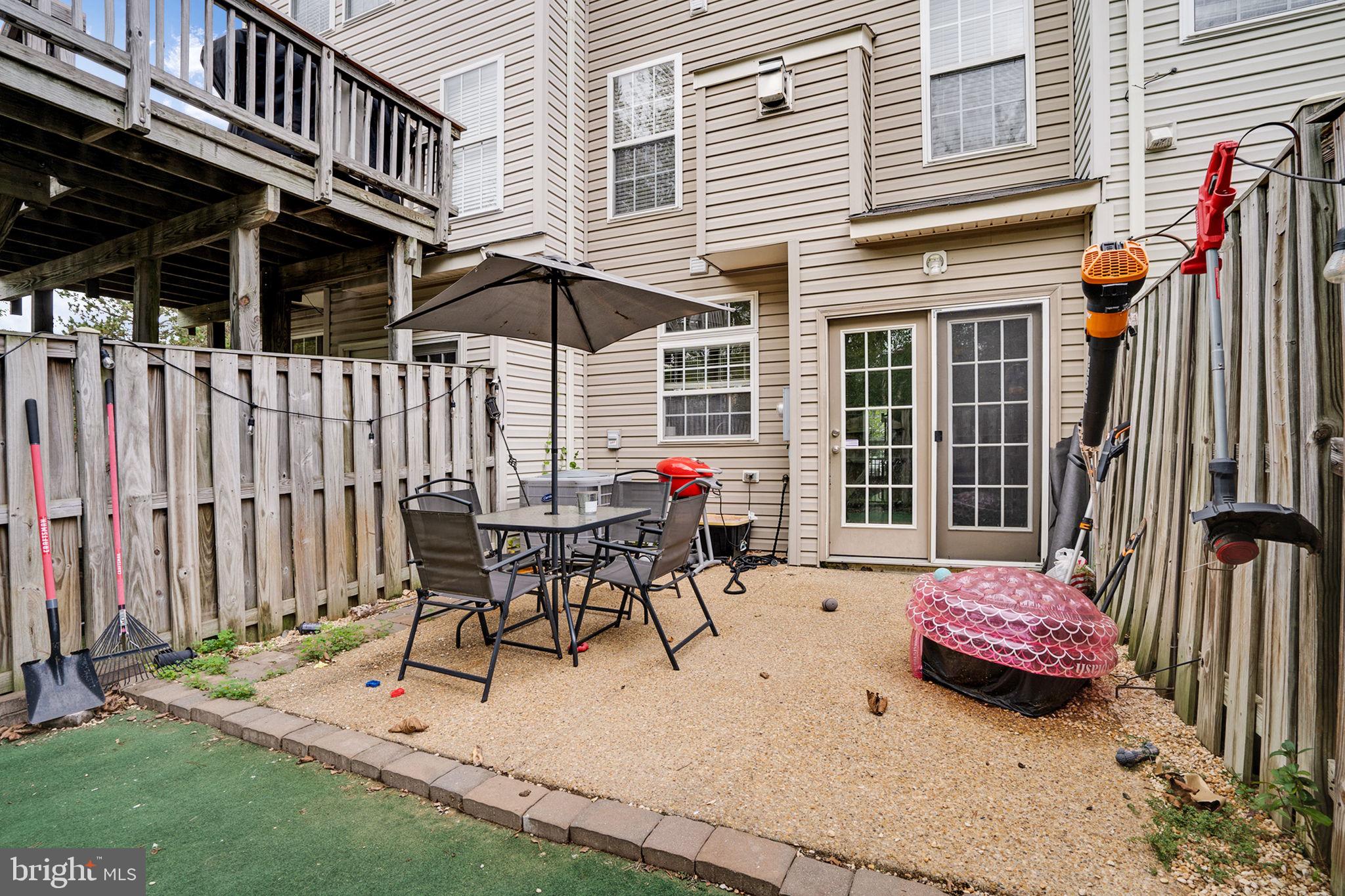 9835 Maitland Loop Bristow, VA 20136 - Photo 33 of 41 a view of a patio with a table and chairs