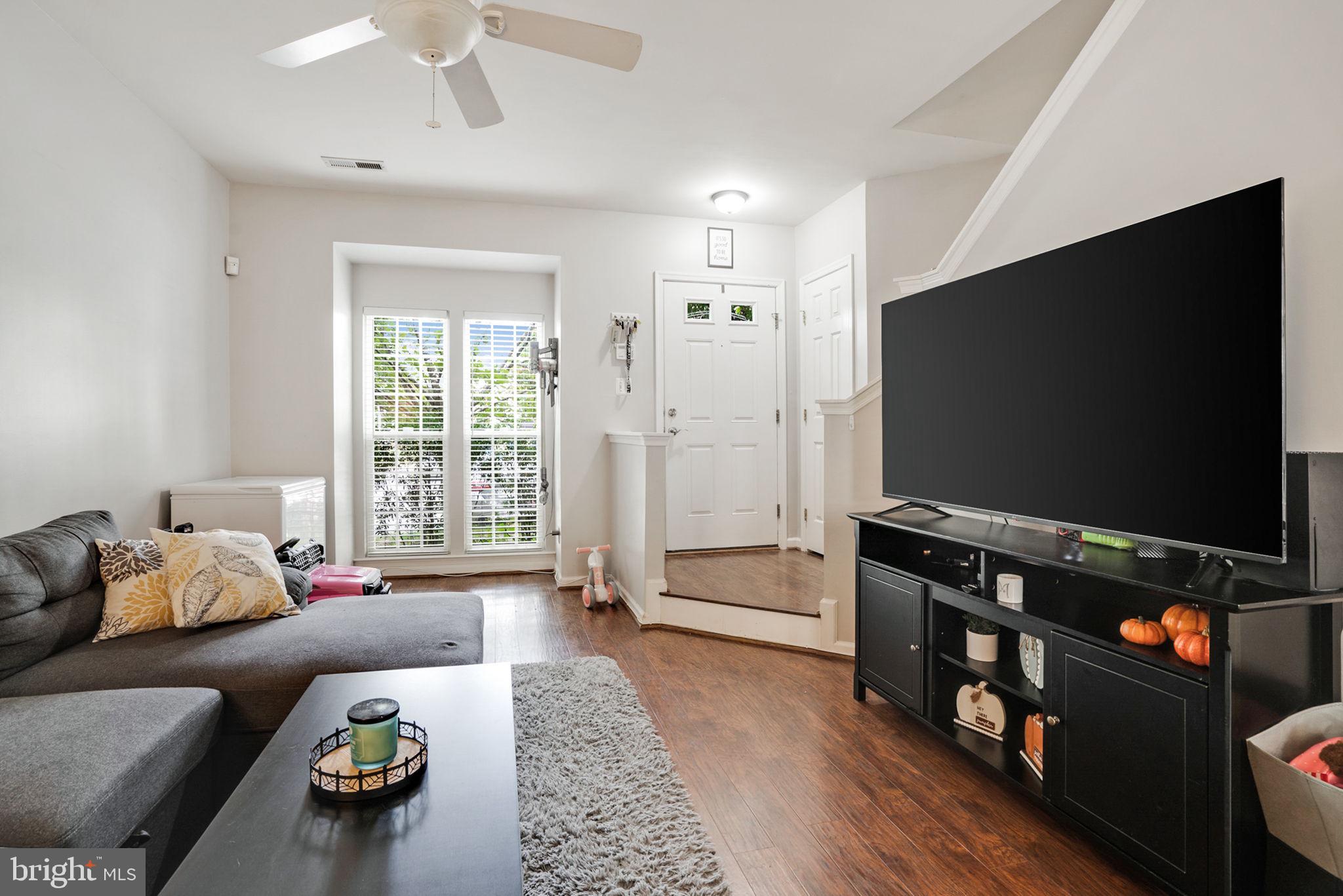 9835 Maitland Loop Bristow, VA 20136 - Photo 6 of 41 a living room with furniture and a flat screen tv
