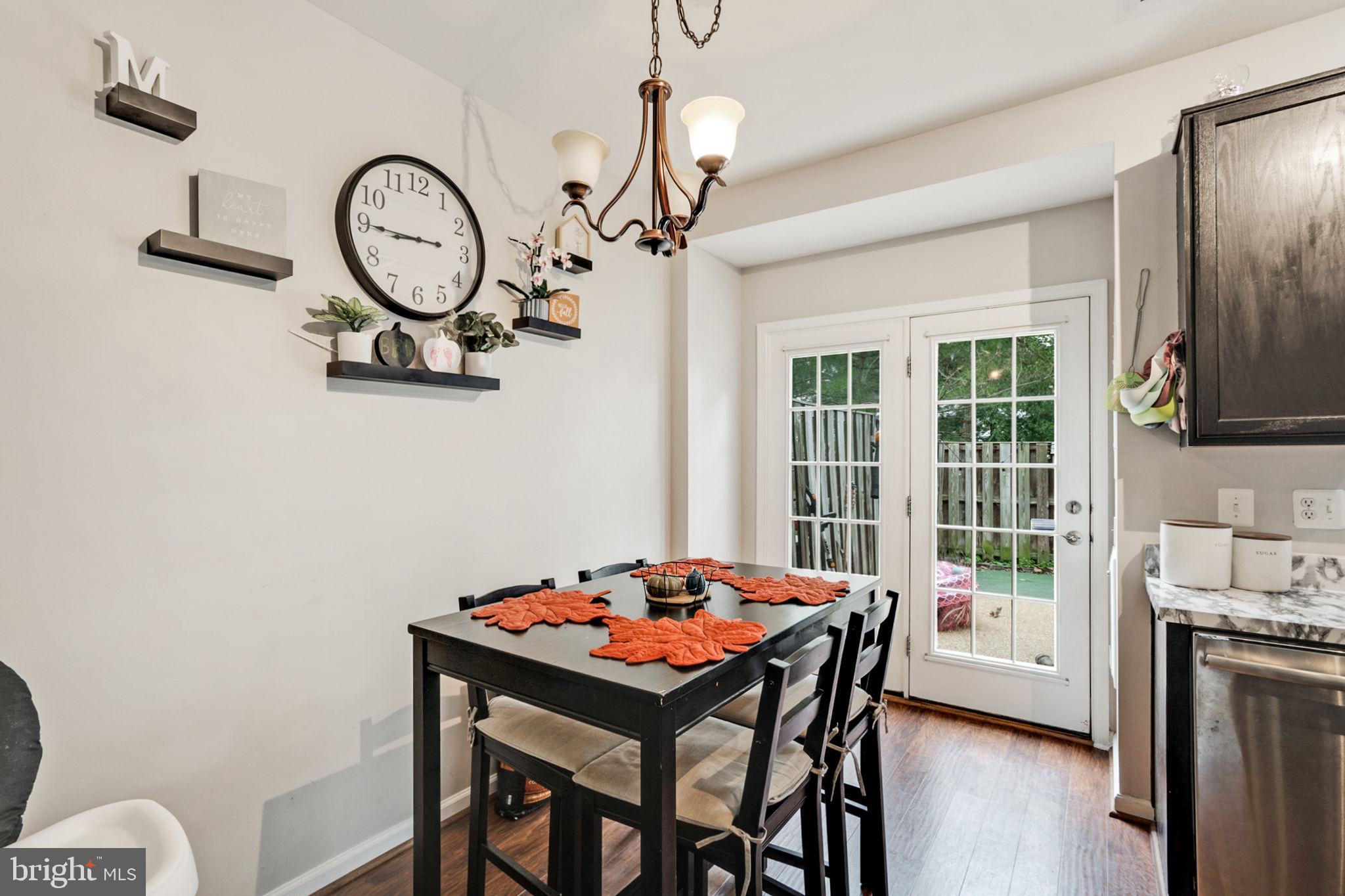 9835 Maitland Loop Bristow, VA 20136 - Photo 7 of 41 a dining room with a table chairs and chandelier