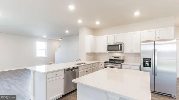 a kitchen with cabinets a sink and stainless steel appliances