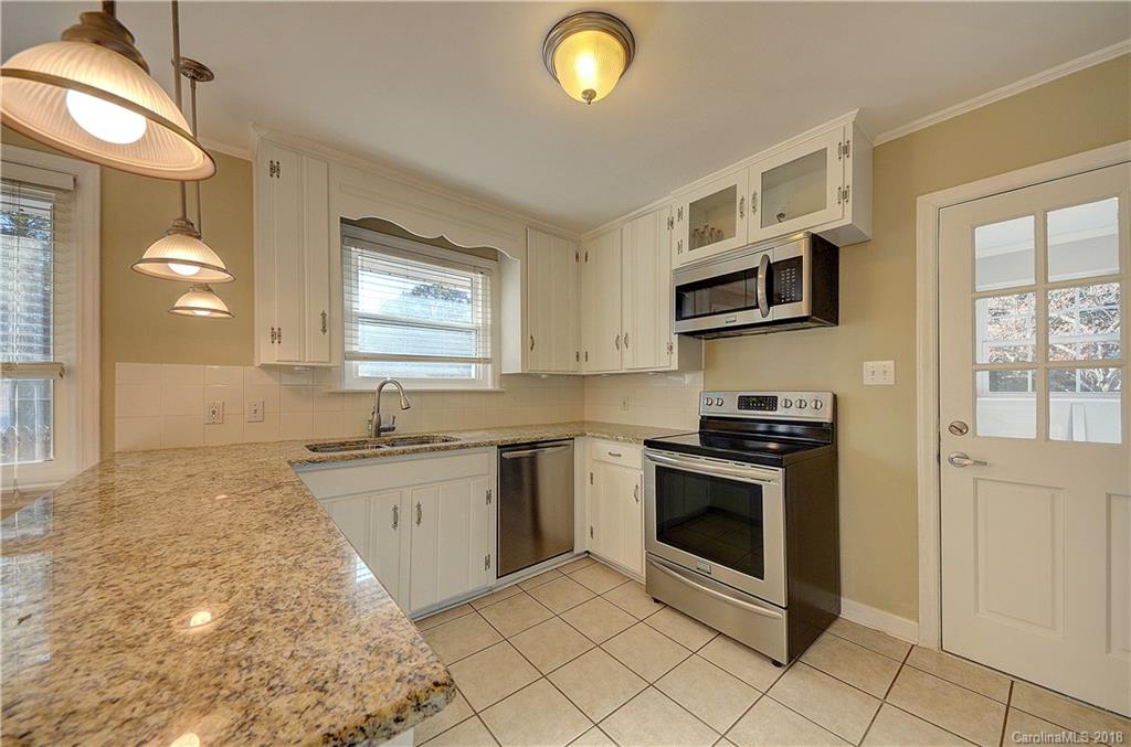 4301 Applegate Road Charlotte, NC 28209 - Photo 12 of 30 a kitchen with stainless steel appliances granite countertop a stove a sink and a microwave