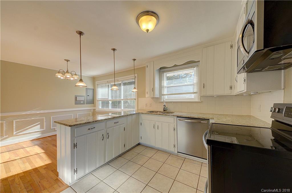 4301 Applegate Road Charlotte, NC 28209 - Photo 15 of 30 a kitchen with a sink window and cabinets