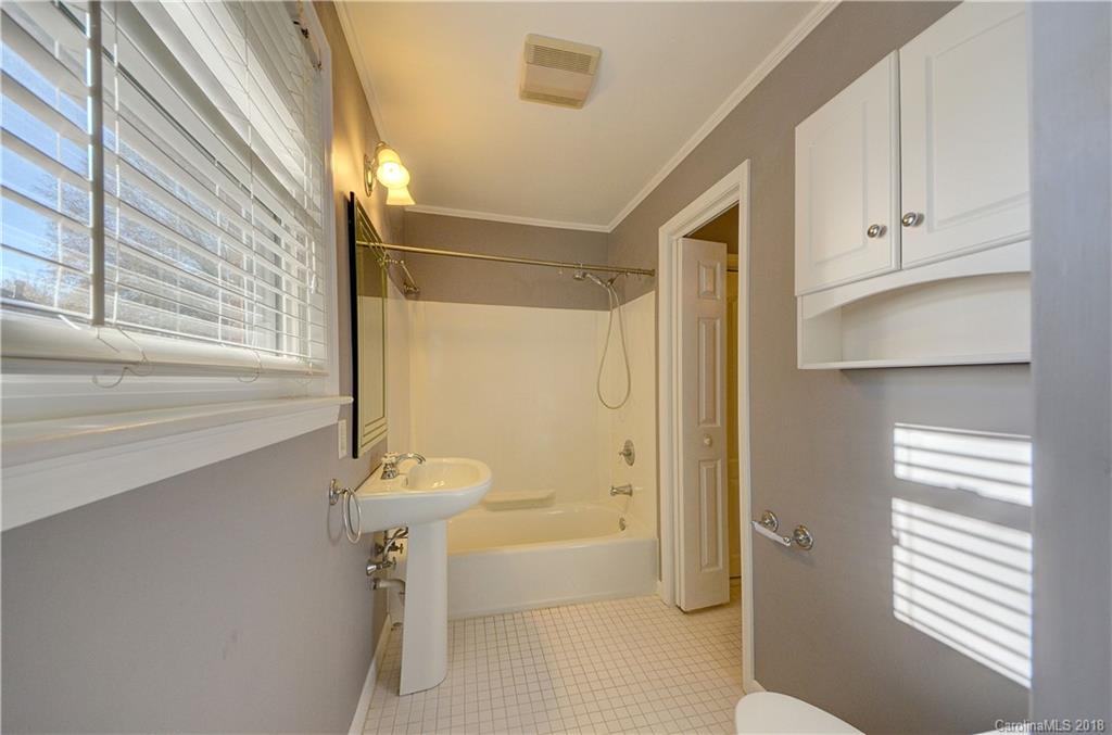4301 Applegate Road Charlotte, NC 28209 - Photo 21 of 30 a bathroom with a sink a toilet and shower