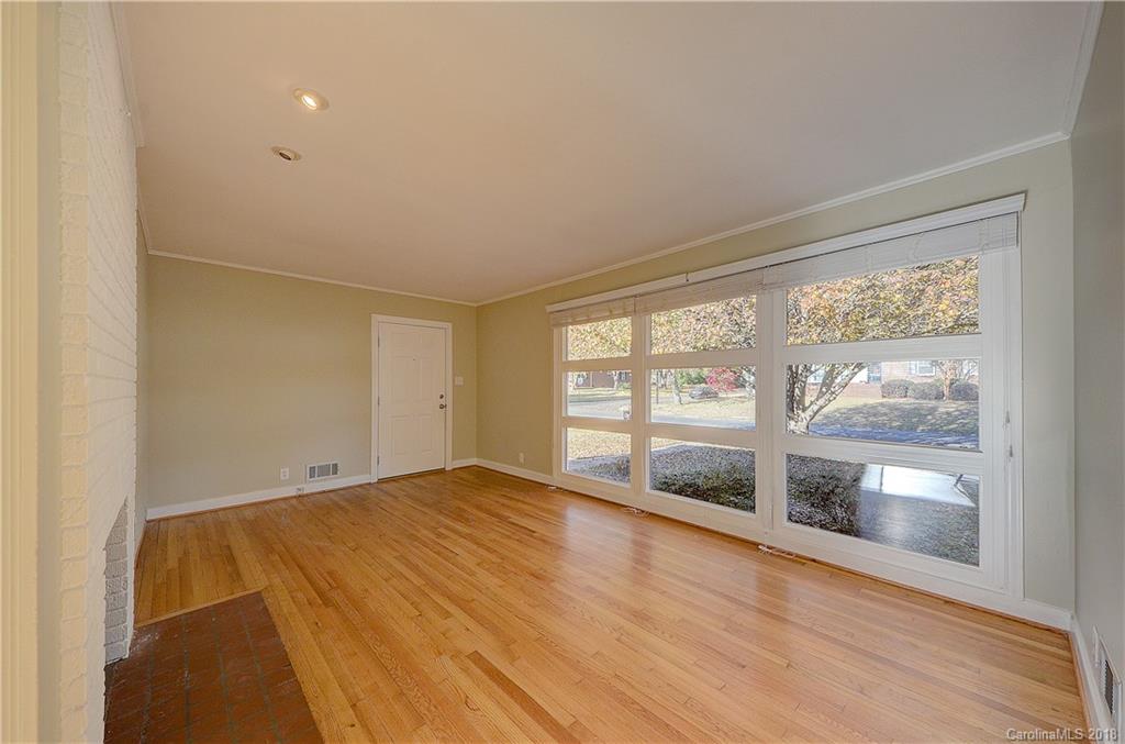 4301 Applegate Road Charlotte, NC 28209 - Photo 6 of 30 a view of an empty room with a window and wooden floor