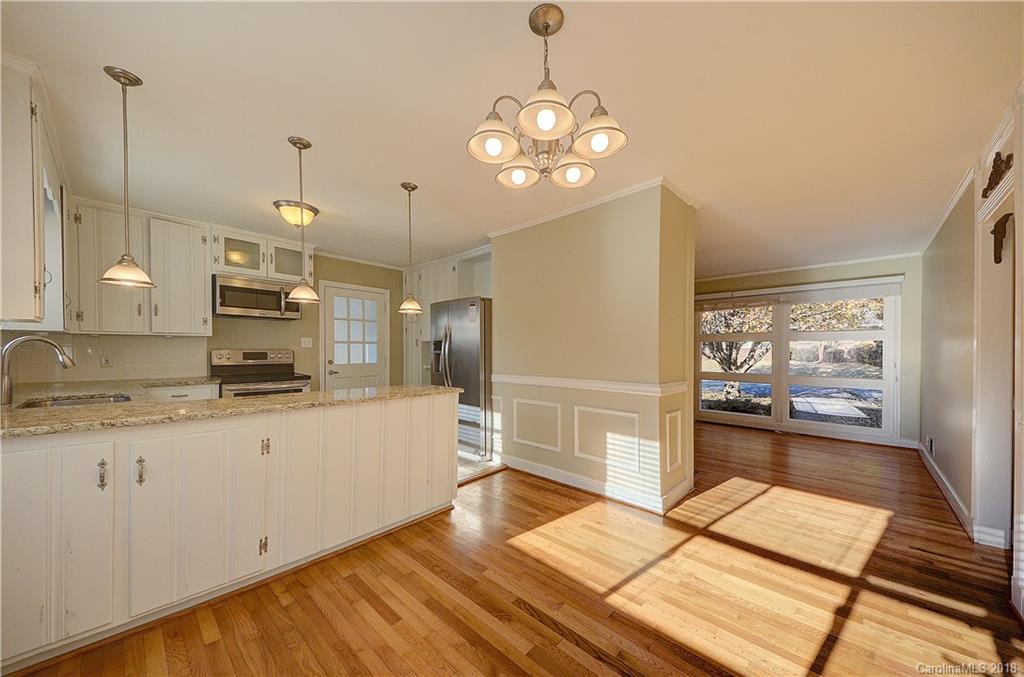 4301 Applegate Road Charlotte, NC 28209 - Photo 9 of 30 a large kitchen with stainless steel appliances kitchen island granite countertop a sink and cabinets