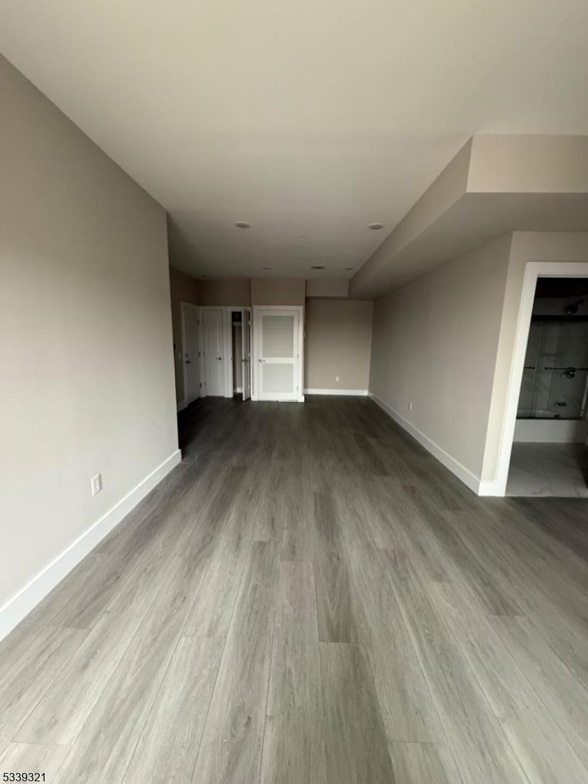 1022 Main Street, Unit 404 Paterson, NJ 07503 - Photo 2 of 7 wooden floor in an empty room with a window