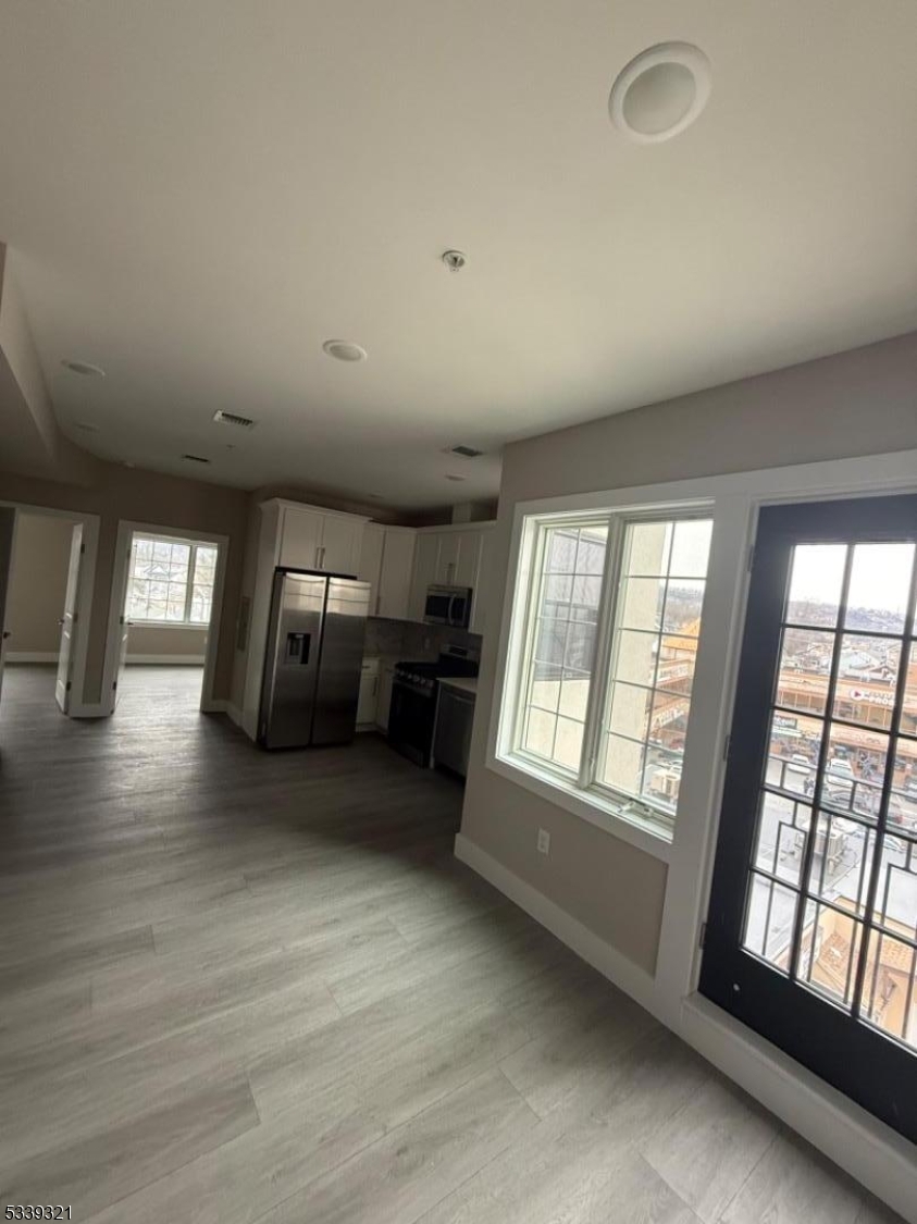 1022 Main Street, Unit 404 Paterson, NJ 07503 - Photo 3 of 7 a living room with furniture and a large window