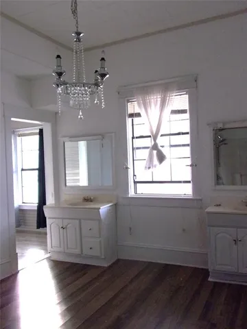a view of a room with wooden floor