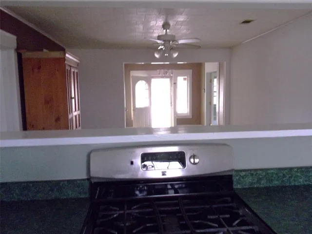 a vase of flowers sitting on a table with chairs
