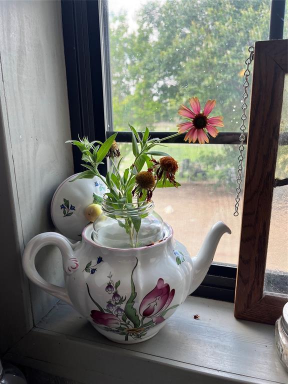 325 C R 100 San Saba, TX 76877 - Photo 19 of 21 a vase of flowers sitting on a table with chairs