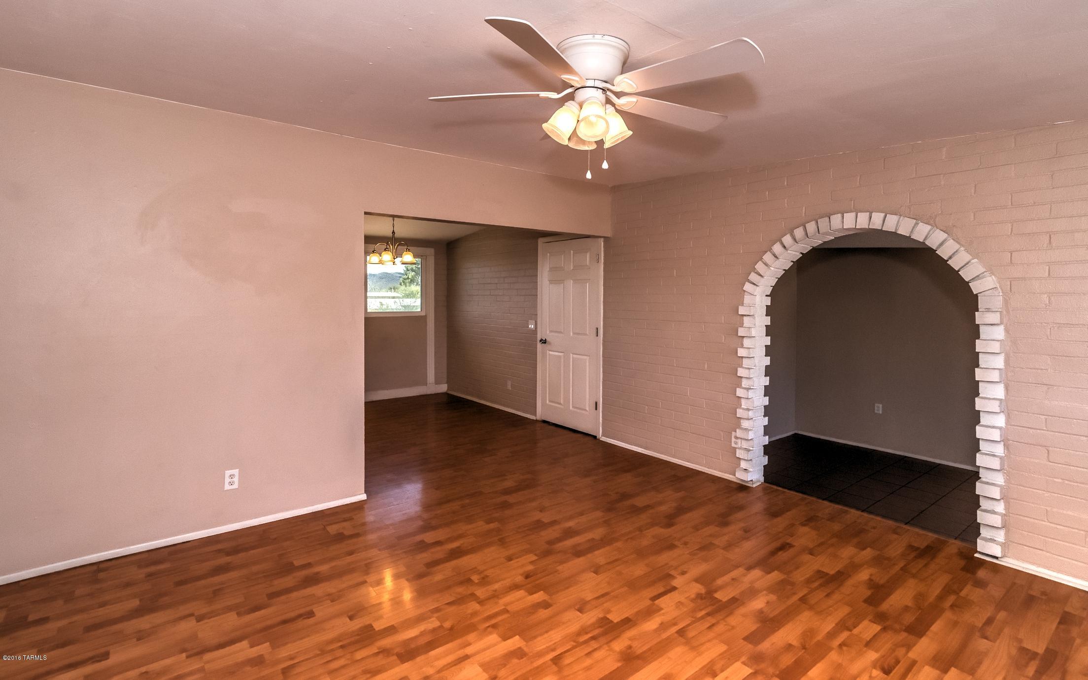 1807 West Merlin Road Tucson, AZ 85713 - Photo 12 of 34 wooden floor in an empty room with a window