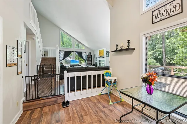 a living room with furniture kitchen appliances and a kitchen view