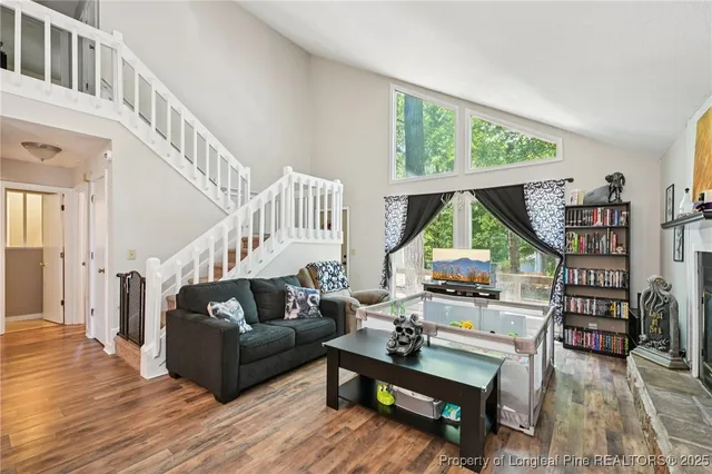 a living room with furniture and a wooden floor