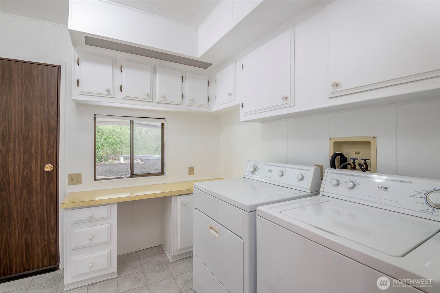 201 Union Avenue Southeast, Unit 147 Renton, WA 98059 - Photo 15 of 20 a view of washer and dryer with white cabinets