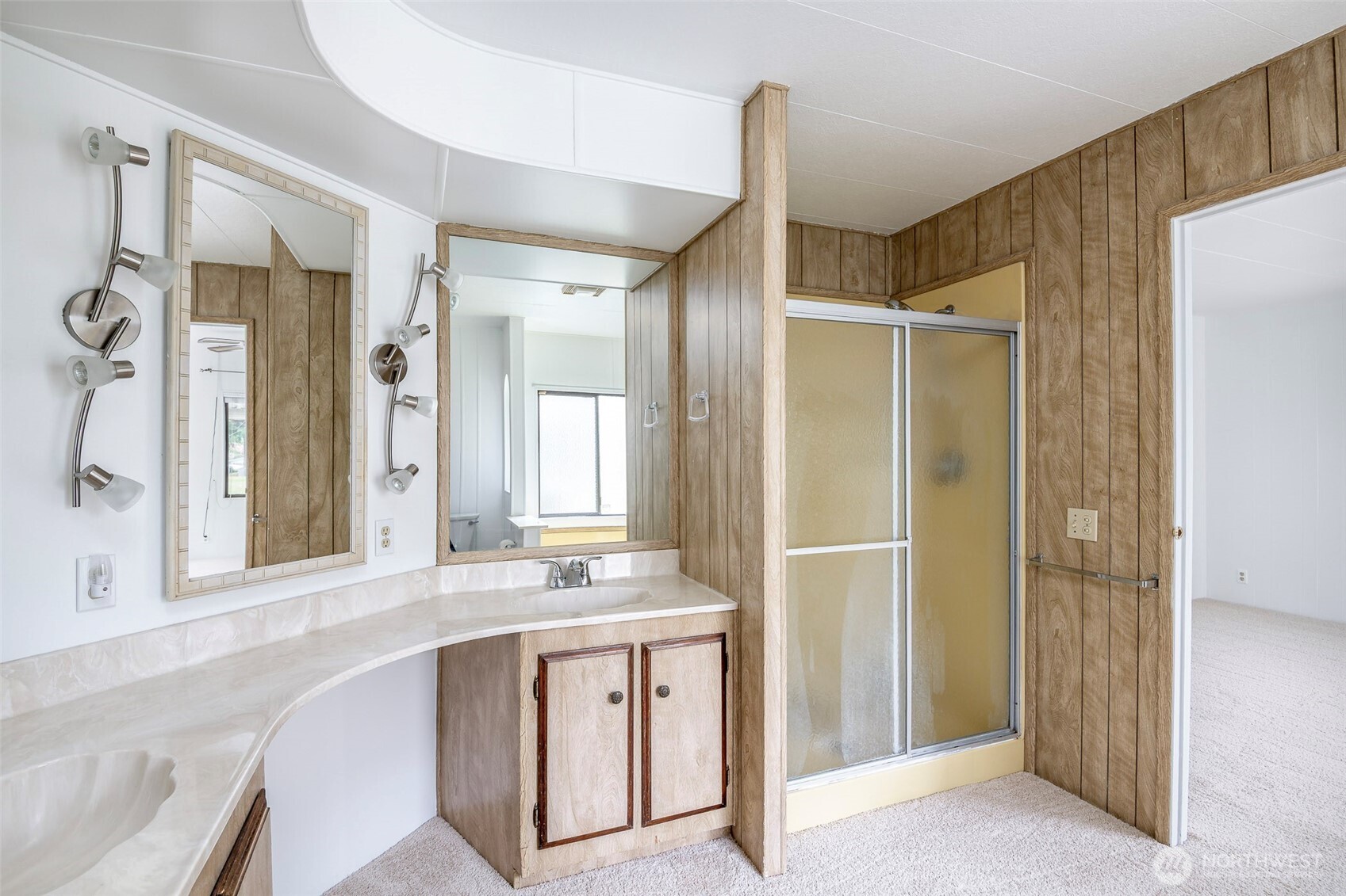 201 Union Avenue Southeast, Unit 147 Renton, WA 98059 - Photo 17 of 20 a spacious bathroom with a shower sink and mirror