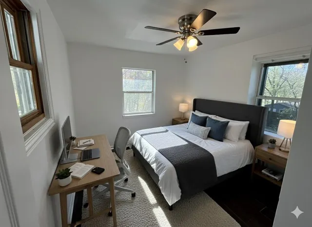 a bedroom with a bed and a chandelier