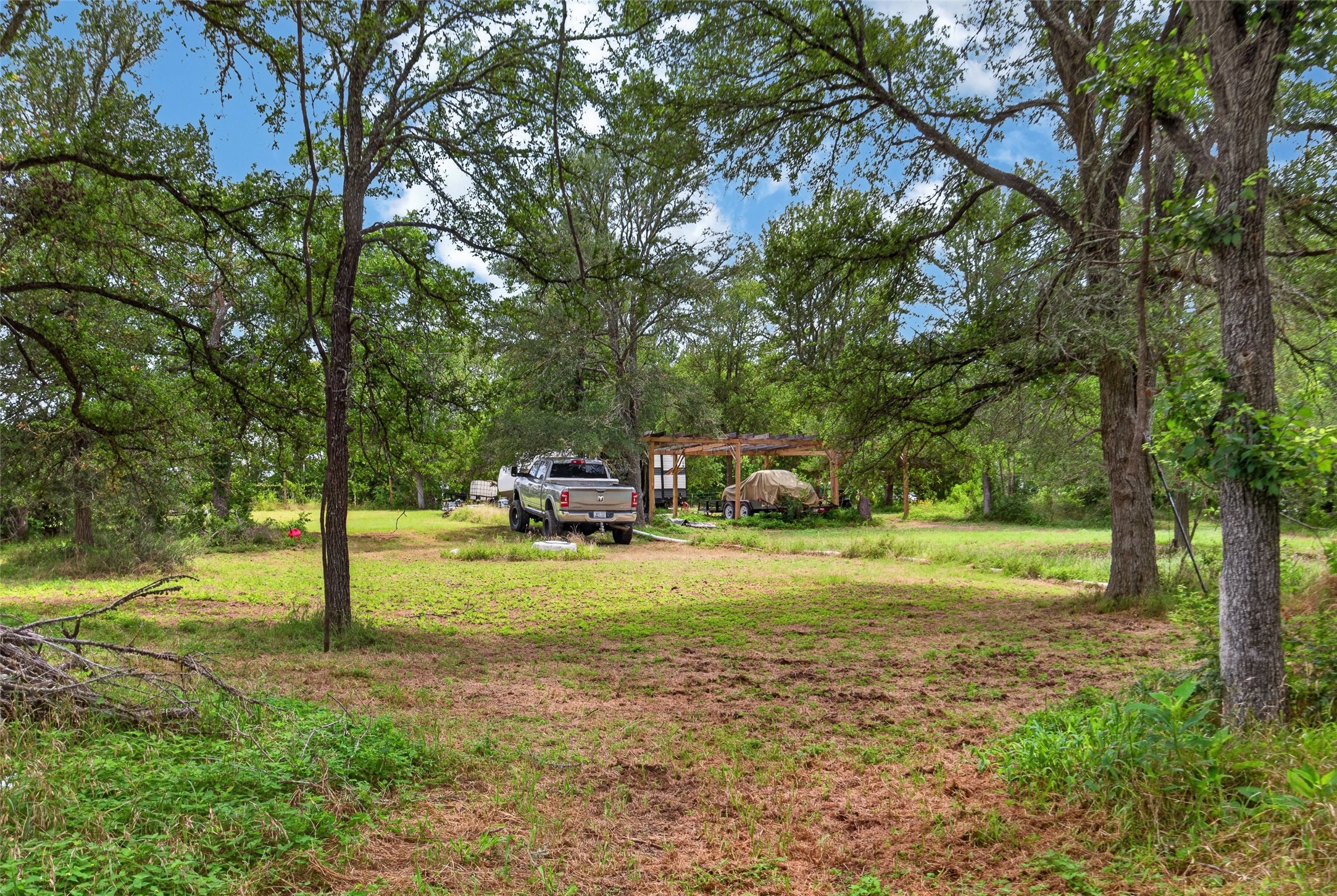266 Beaver Road Elgin, TX 78621 - Photo 28 of 40 A tranquil, tree-dotted landscape offers a serene escape, perfect for outdoor living and recreation.