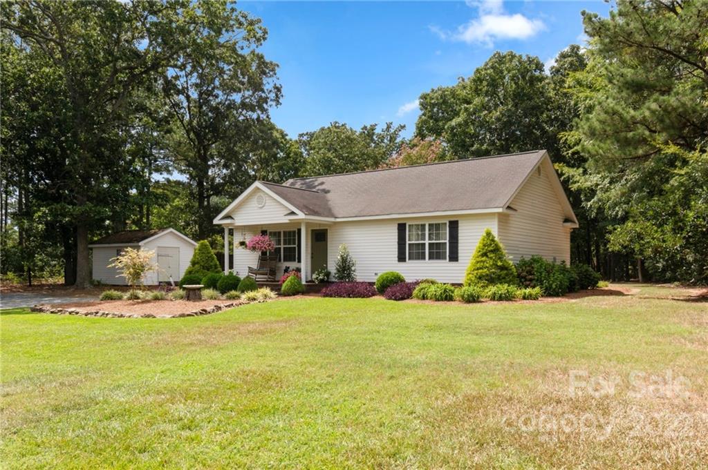 1801 Mullis Road Monroe, NC 28112 - Photo 5 of 27 a front view of a house with a yard and garage