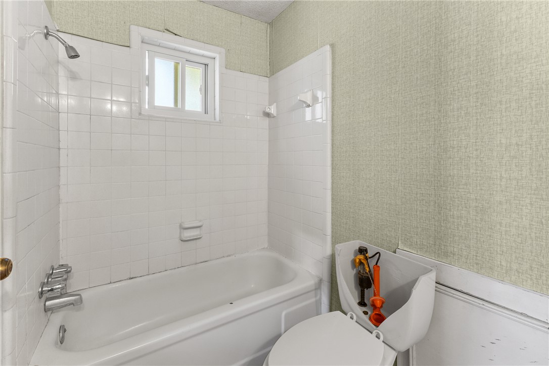 3003 Kim Street Bryan, TX 77803 - Photo 13 of 21 a bathroom with a bathtub and a shower