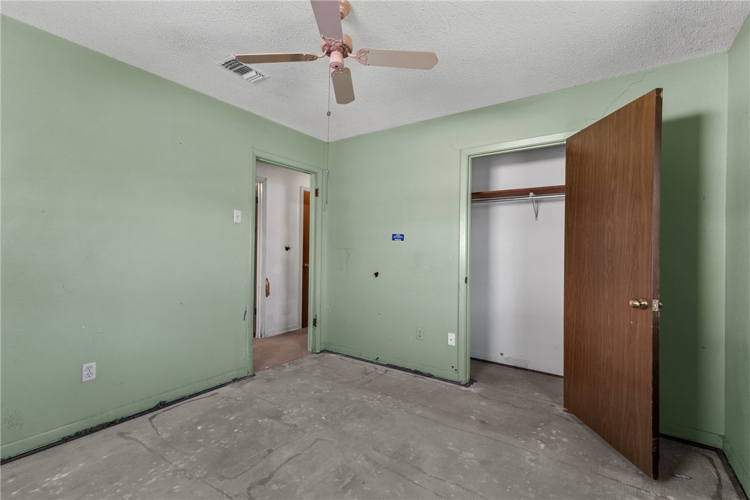 3003 Kim Street Bryan, TX 77803 - Photo 15 of 21 an empty room with closet and a chandelier fan