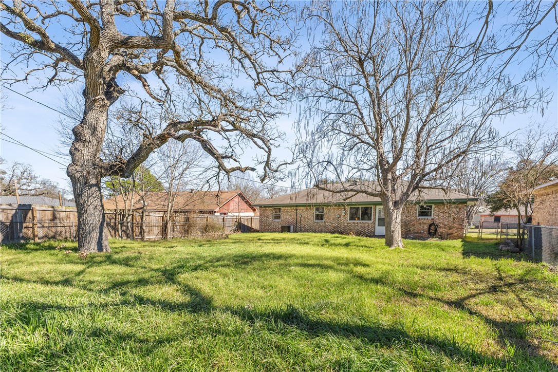 3003 Kim Street Bryan, TX 77803 - Photo 16 of 21 a view of a yard with a house in the background