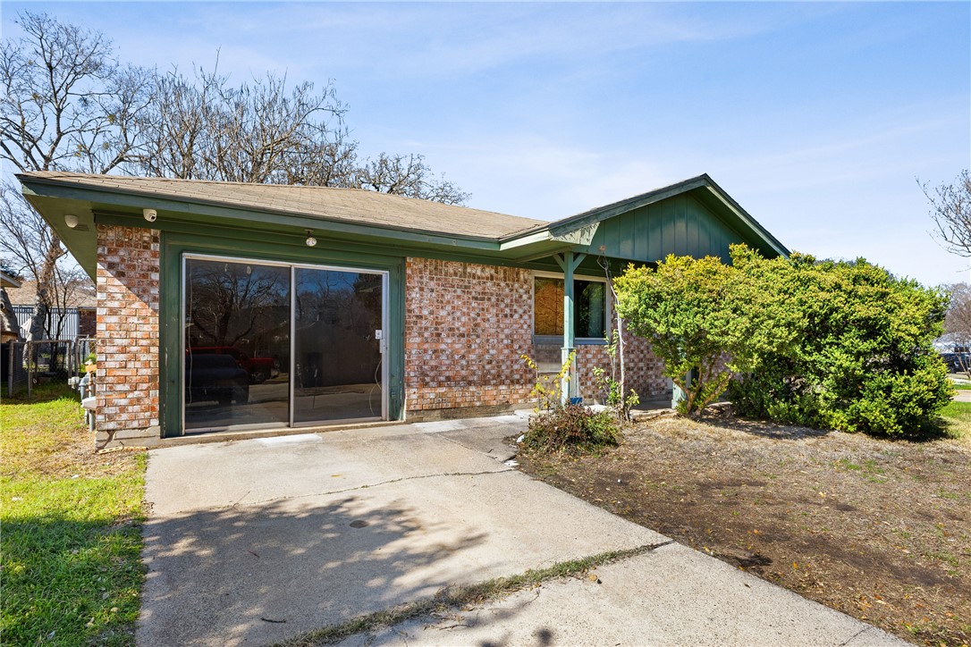 3003 Kim Street Bryan, TX 77803 - Photo 2 of 21 a front view of a house with a garden