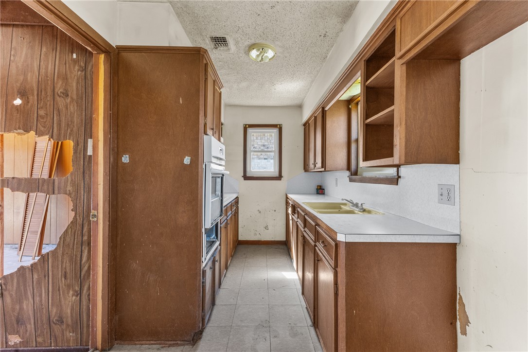 3003 Kim Street Bryan, TX 77803 - Photo 6 of 21 a en suite bathroom with a granite countertop sink and a mirror