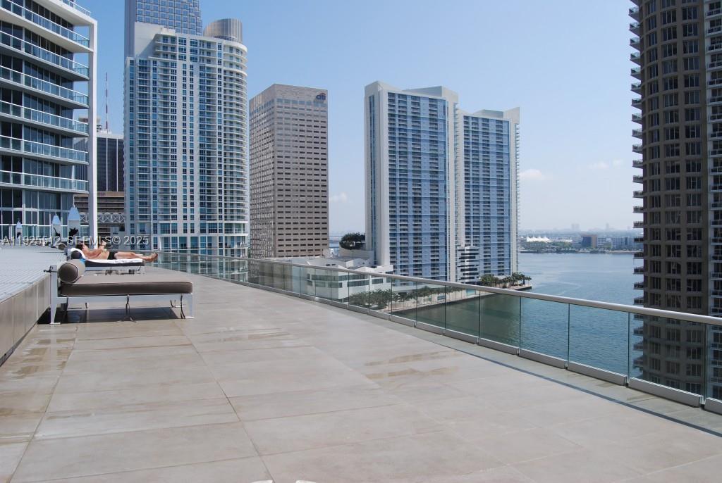 485 Brickell Avenue, Unit 3307 Miami, FL 33131 - Photo 14 of 17 a swimming pool with outdoor seating