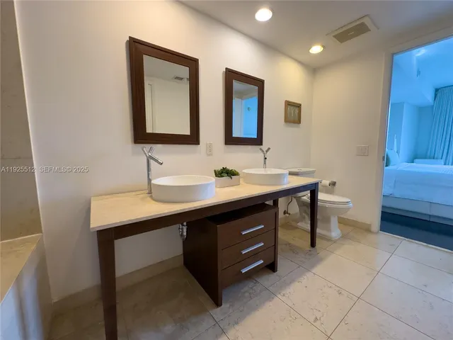 a bathroom with a sink double vanity and a mirror