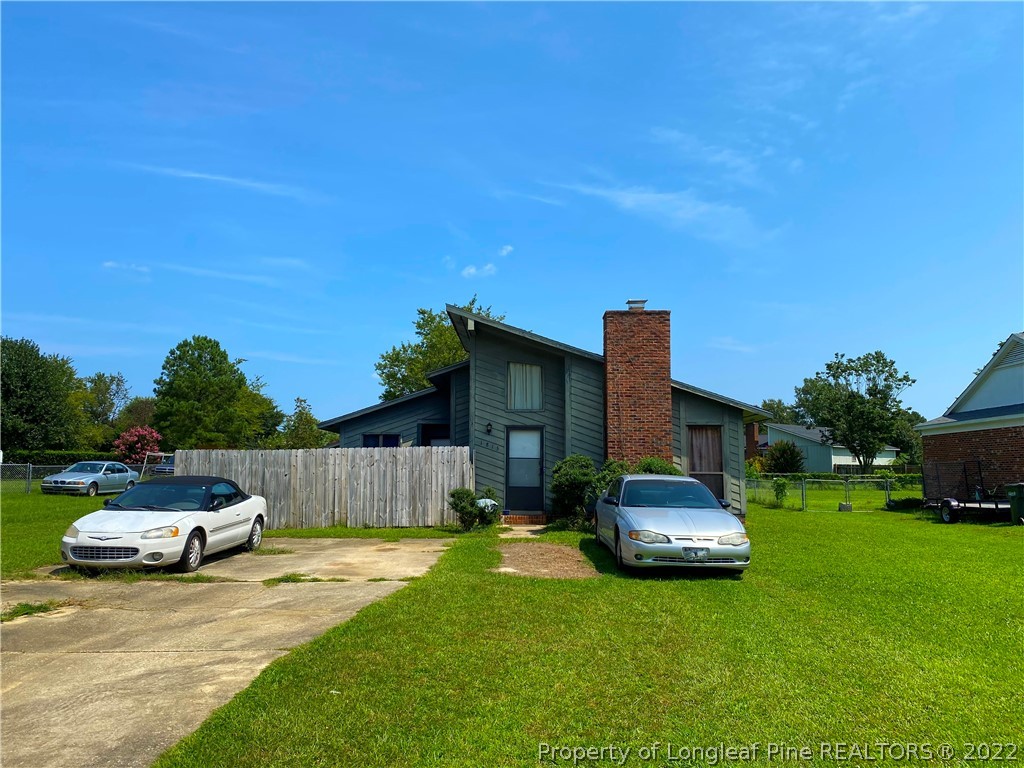 1815 Rivergate Road Fayetteville, NC 28304 - Photo 1 of 14 a car parked in front of a house and a yard