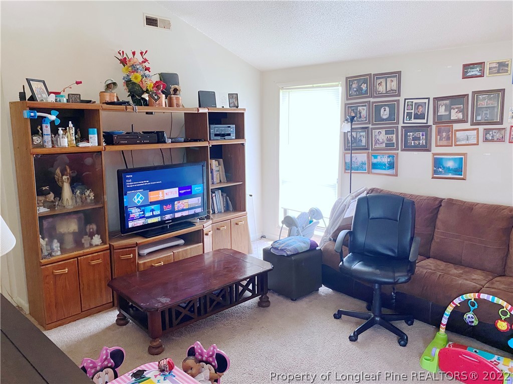1815 Rivergate Road Fayetteville, NC 28304 - Photo 2 of 14 a living room with furniture and a flat screen tv
