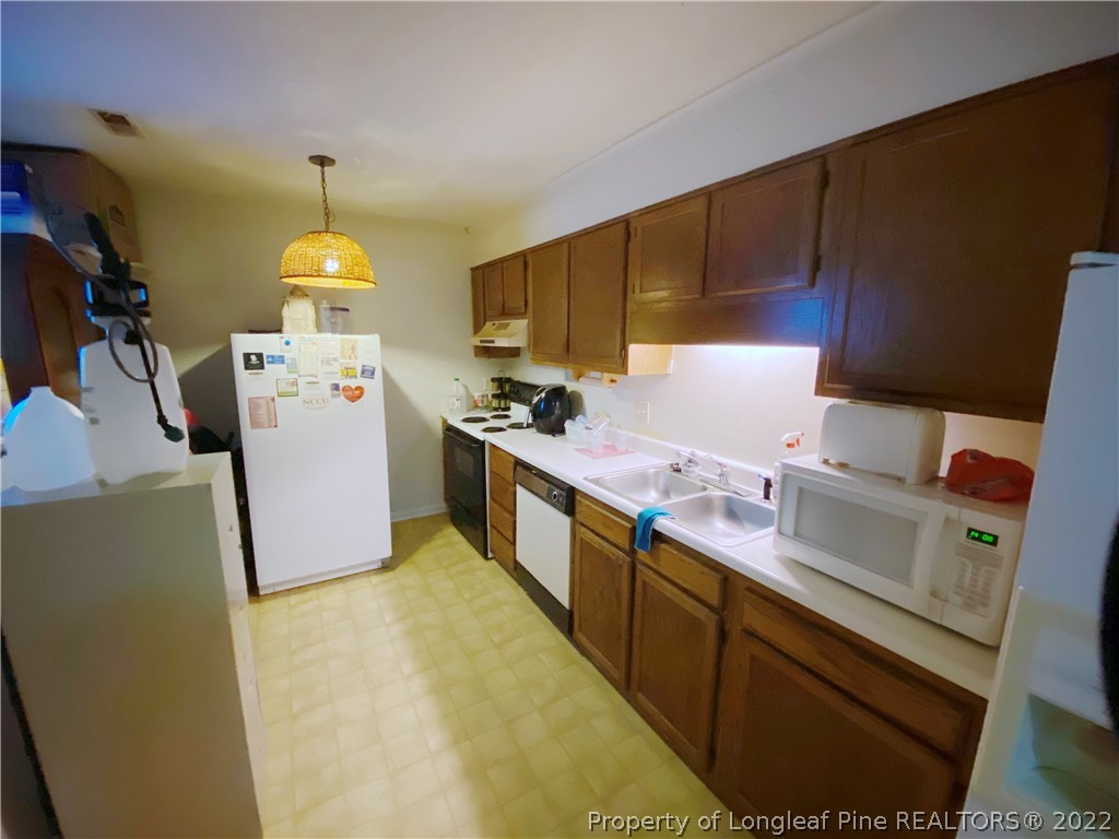 1815 Rivergate Road Fayetteville, NC 28304 - Photo 5 of 14 a kitchen with stainless steel appliances a sink a stove and a refrigerator